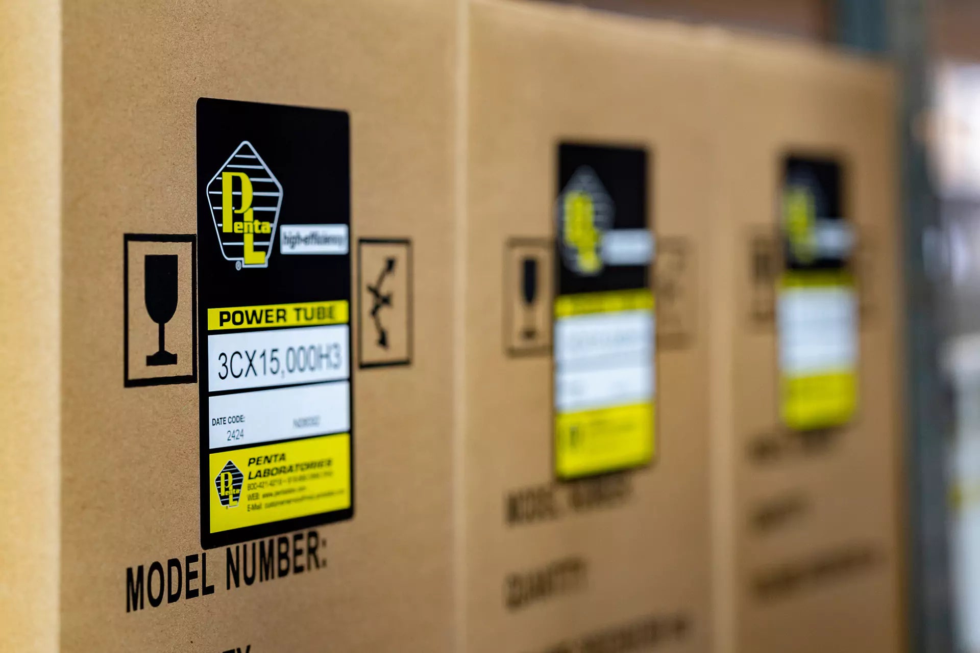 Penta Labs power tube shipping boxes with product labels and fragile handling symbols.